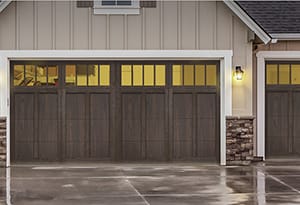 New replacement garage doors on a ranch home with one single and double garage doors