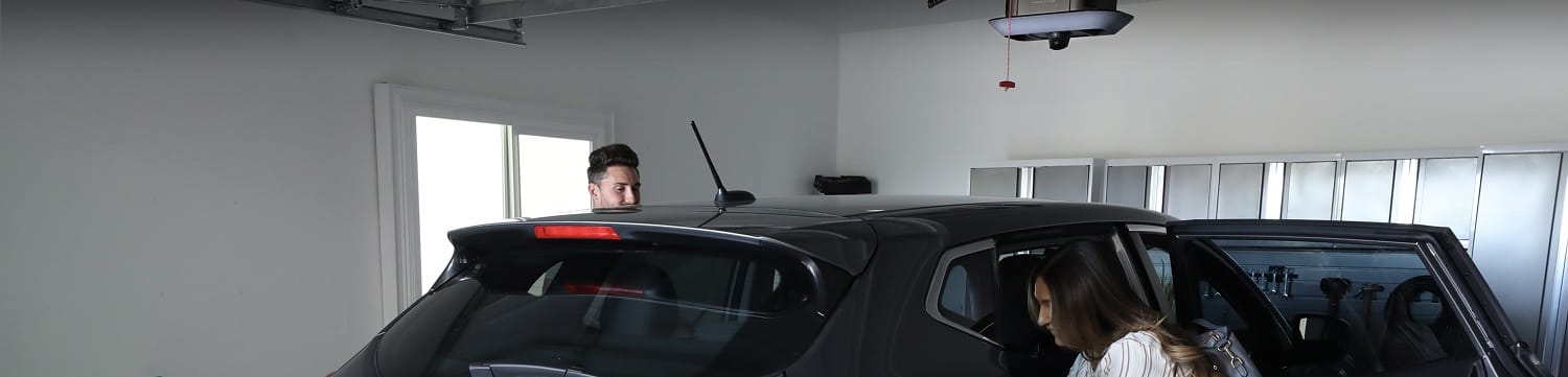 Garage door opener above a vehicle in a home garage that was conveniently opened with a garage door remote