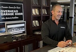 Owner of AV Overhead Garage Door working with customers in the Chicago area showroom