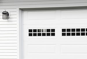 Steel raised long panel white garage door with stockton windows on a double residential door