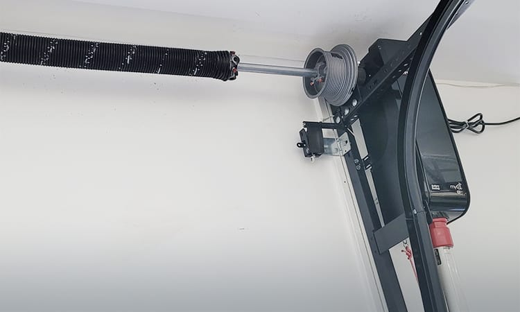Residential garage door cable with spring, tracks and side mount garage door opener.