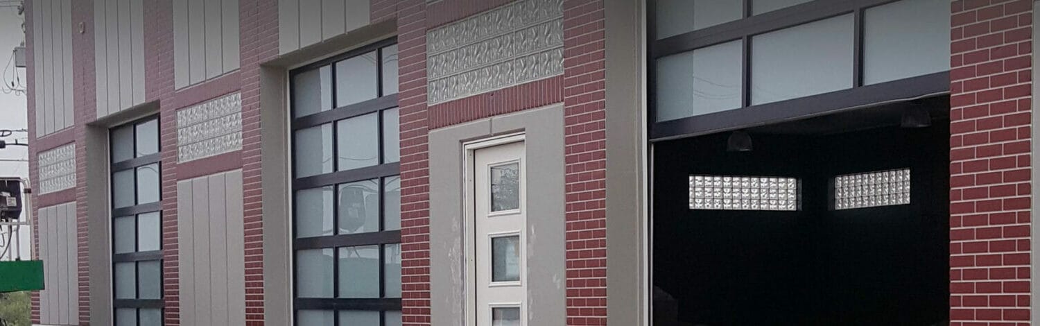 New commercial fullview, black-framed garage doors with frosted glass windows