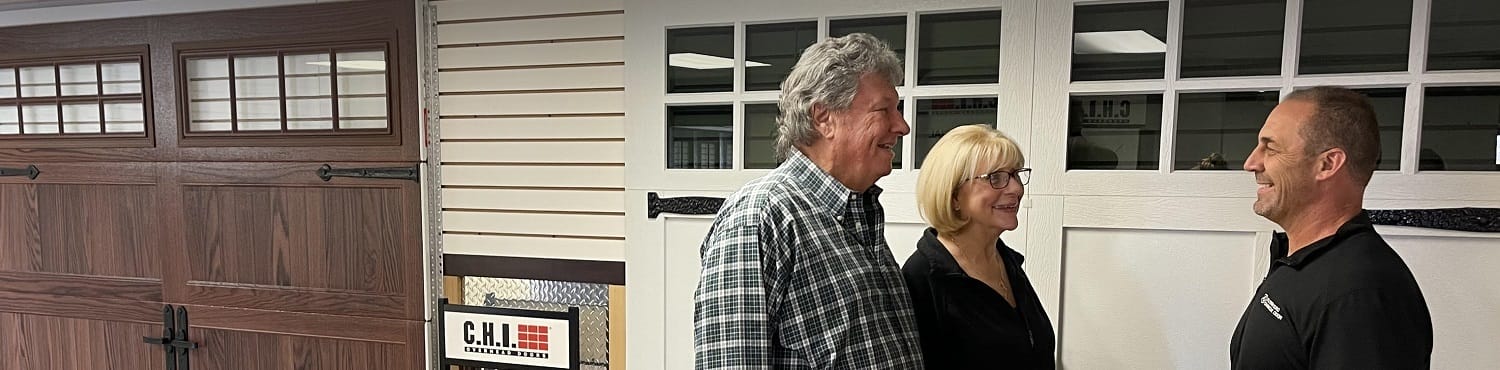Adam Vanda, owner of AV Overhead Garage Door in North Aurora, meeting with customers in their garage door showroom in North Aurora