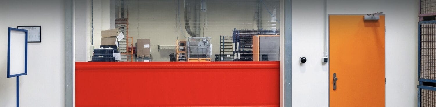 Bright orange commercial pedestrian (man) door installed in a business facility