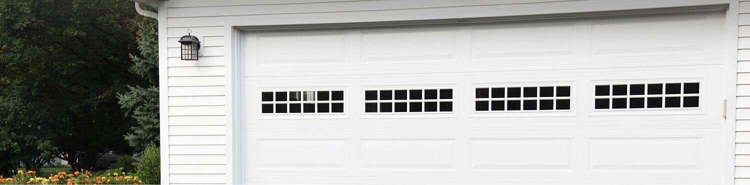 Steel raised long panel white garage door with stockton windows on a double residential door