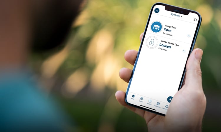 Male using his smartphone and the LiftMaster myQ app to lock his garage door while away enjoying nature