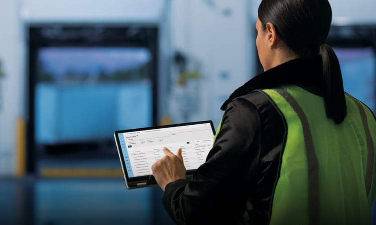 Facility manager using the LiftMaster myQ technology on her laptop to control all entry points in the facility—docks, overhead doors, pedestrian doors, and gates.