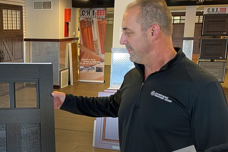 Adam Vanda showing samples in the AV Overhead Garage Door showroom in North Aurora, IL