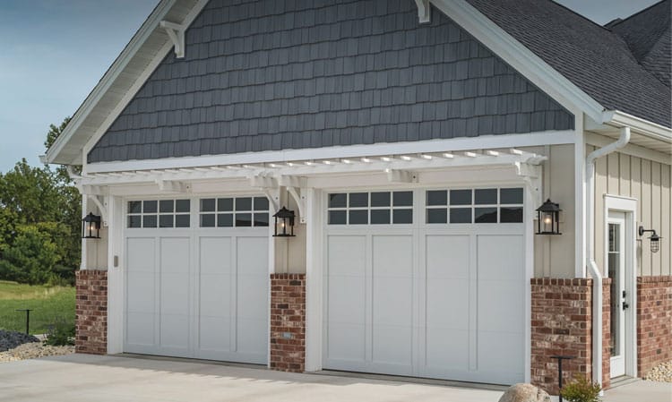 Recent installation service of two single overlay carriage garage doors on a residential garage