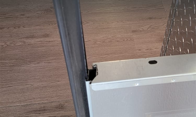 Garage door seal or weatherstrip that can easily slide out and be replaced when damaged.