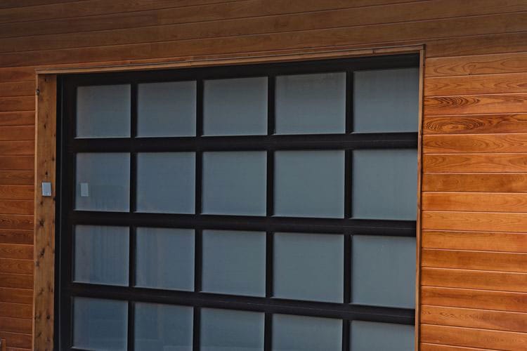 New residential fullview black-framed single garage door with frosted glass