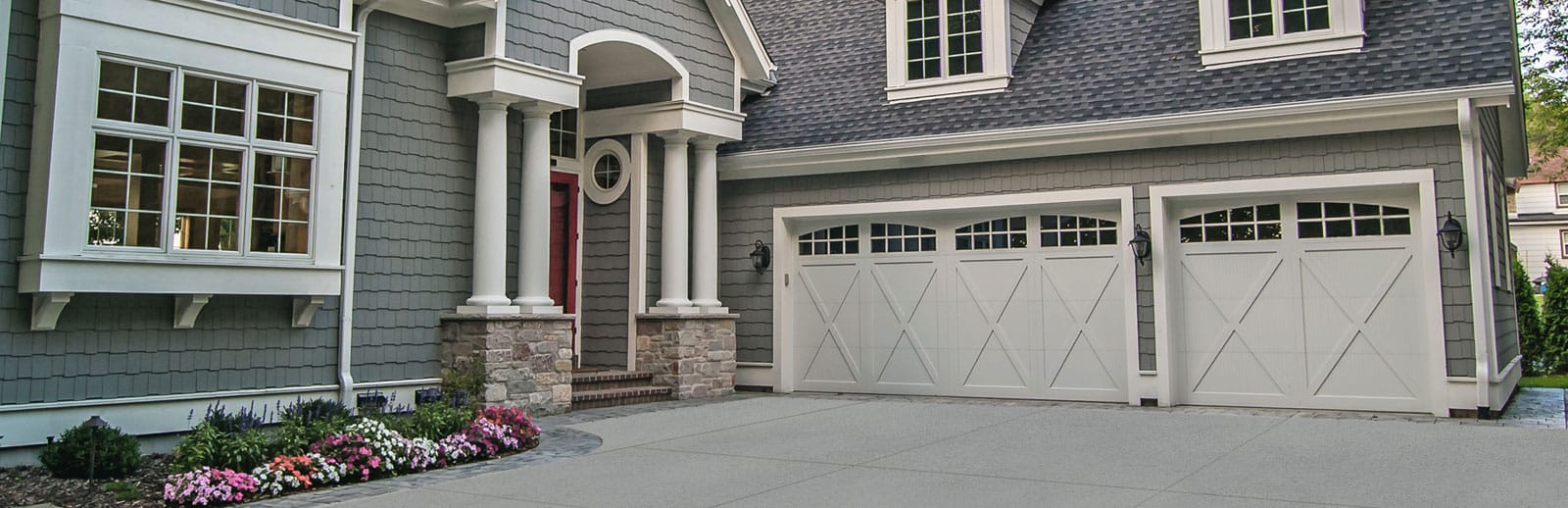 Beautiful white panel carriage garage doors with arched windows, installation service by AV Overhead Garage Door