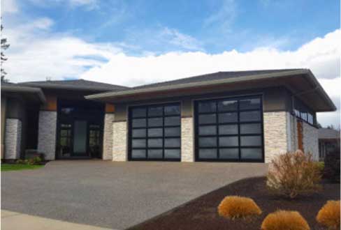 Full-view frosted glass garage doors add value, curb appeal and unique style for this home